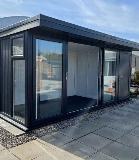 A contemporary dark-framed garden room